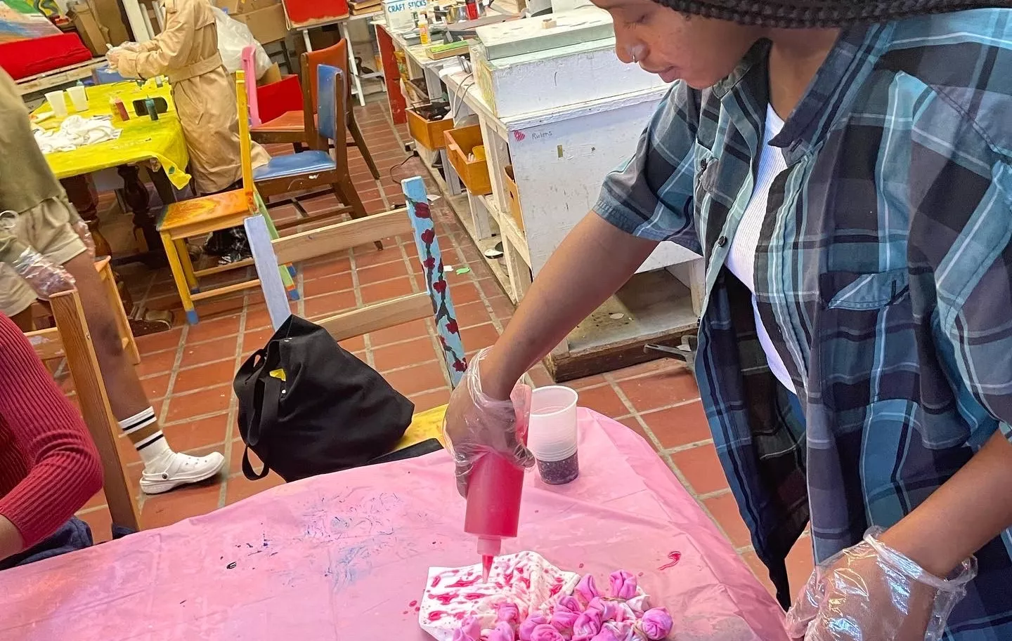 Image of student tie dying a shirt