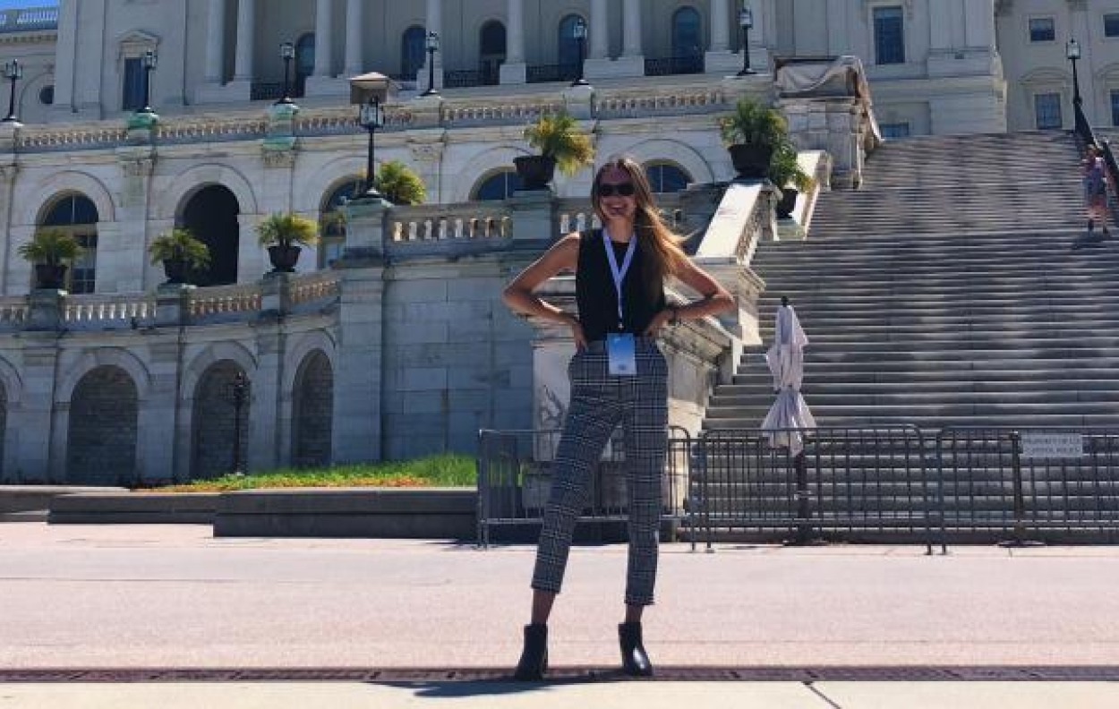 Student standing outside of a building