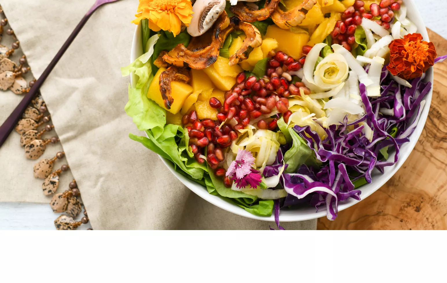 bowl of salad on a placemat with a fork