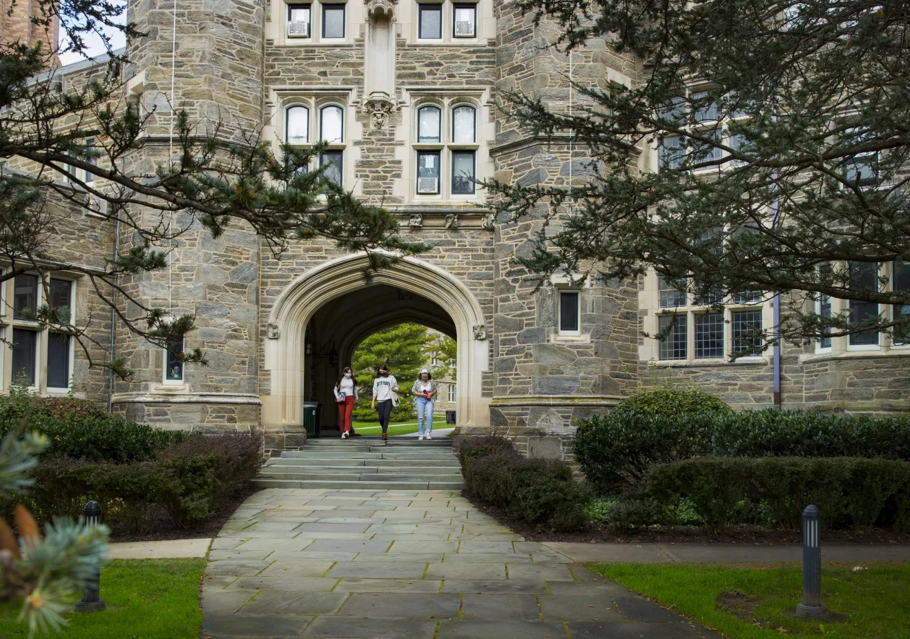 Students walking under Rock arch