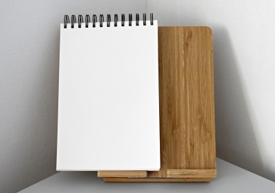 Open notebook standing on a wooden stand