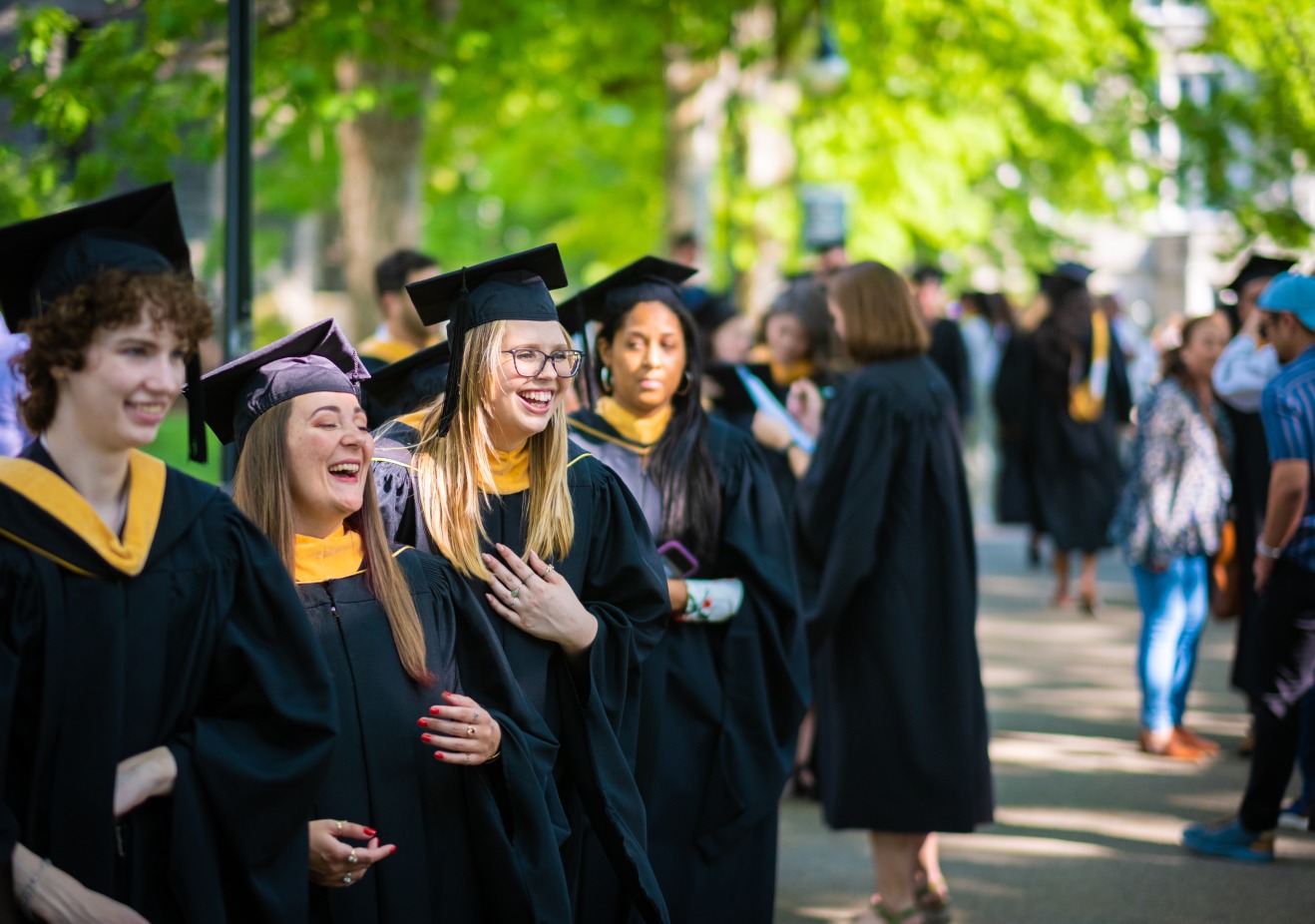 Graduate students lining up on Taylor Drive at Graduate Commencement