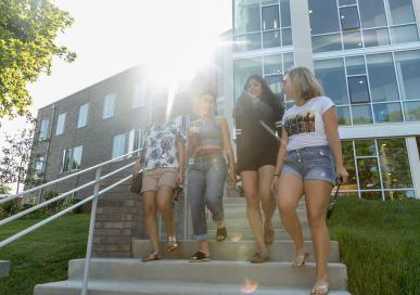 Students walking down the steps of New Dorm