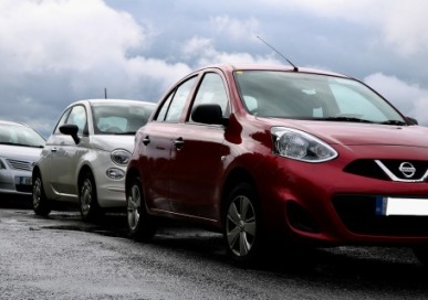 Three cars parked on a road