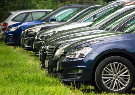 Parked cars near grass