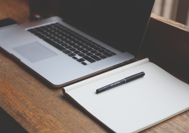 Laptop and Notebook on a Desk