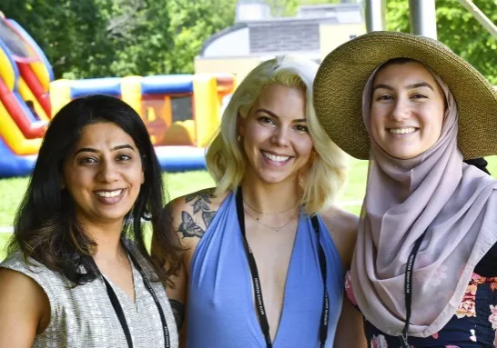 Three alumnae at an event