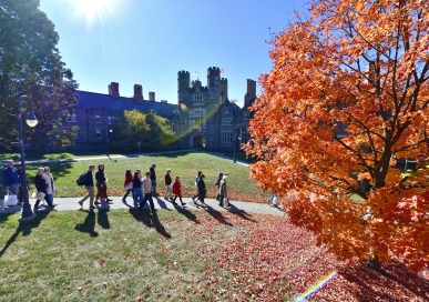 Students and families walking by Rockefeller Hall