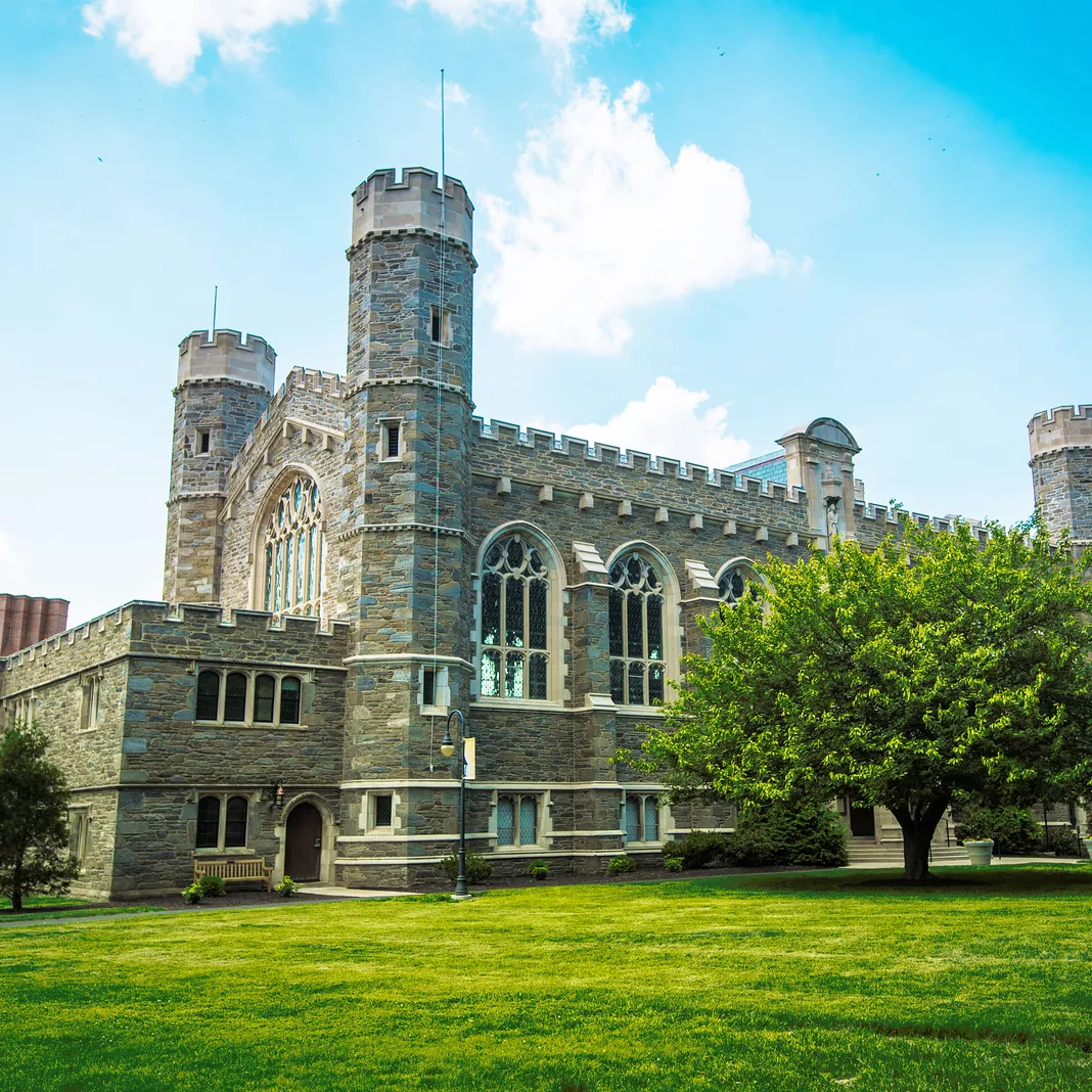 Large stone building with green grass