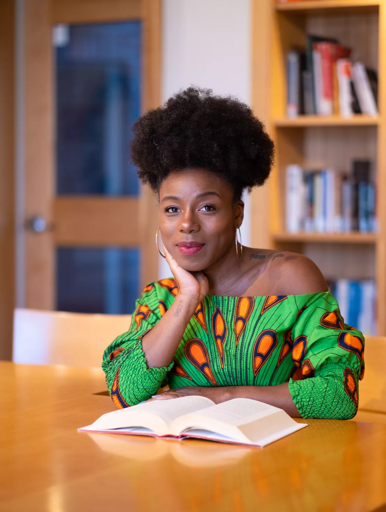 Chanelle Wilson seated at a table with a book