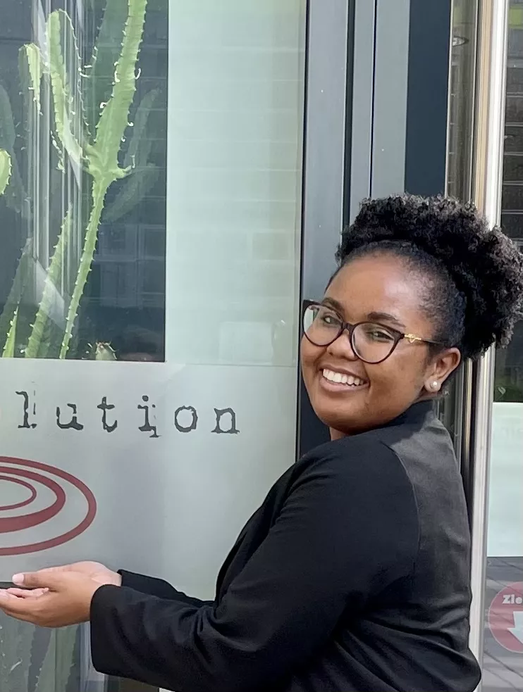 Whitney smiling next to a biolution sign