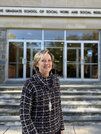 Peggy Robinson standing outside of the GSSWSR building