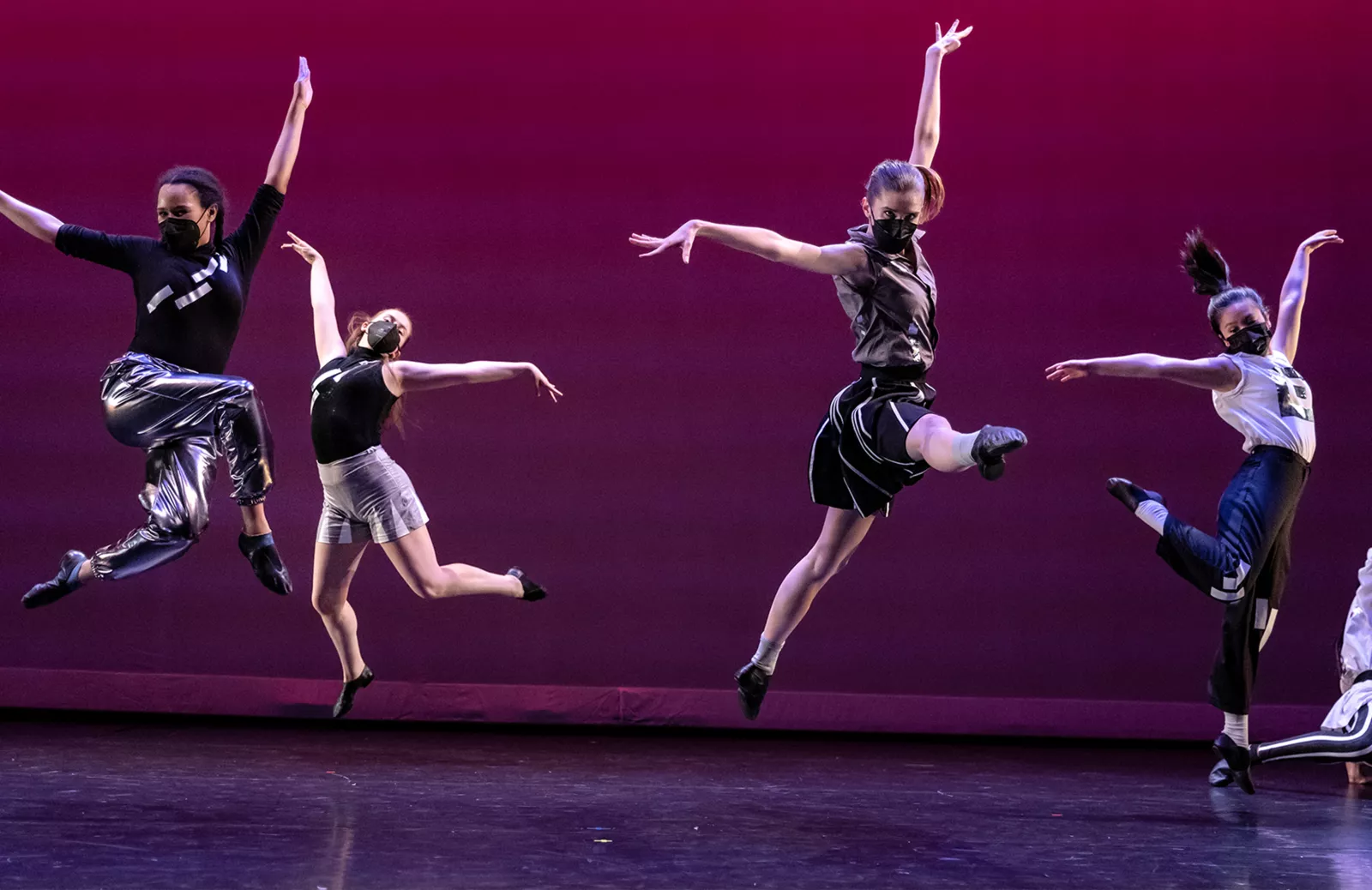 Image of dancers jumping on stage