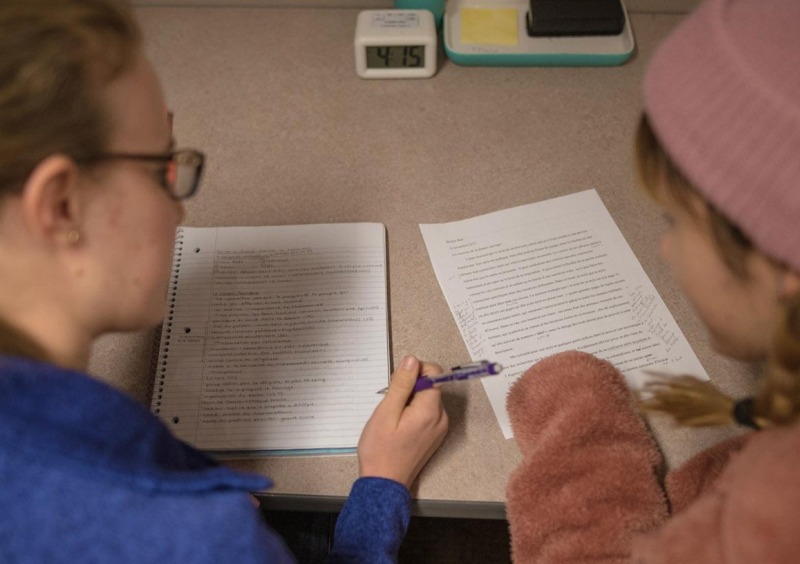 Two students writing