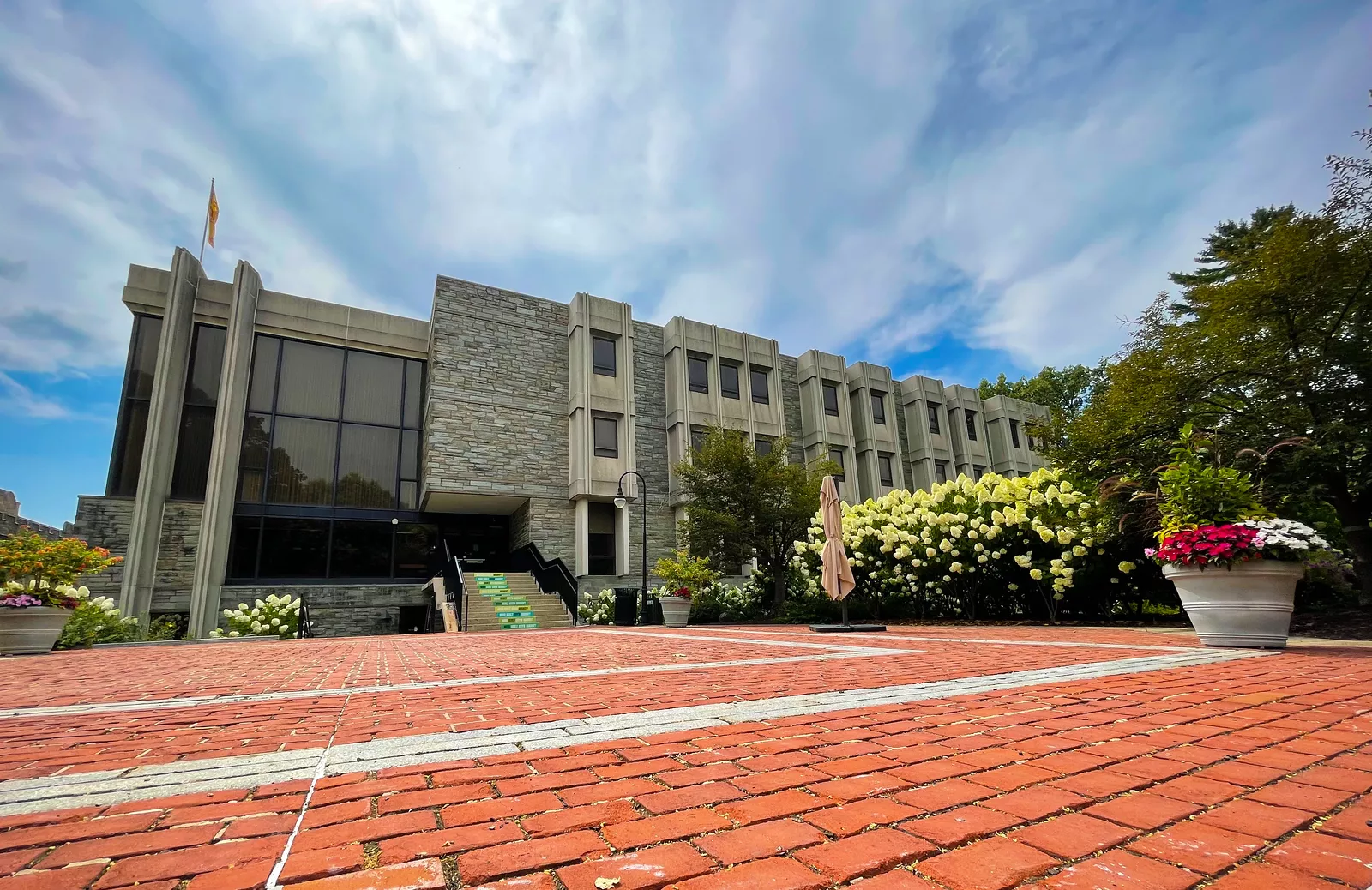 Brick walkway leading to three story stone building