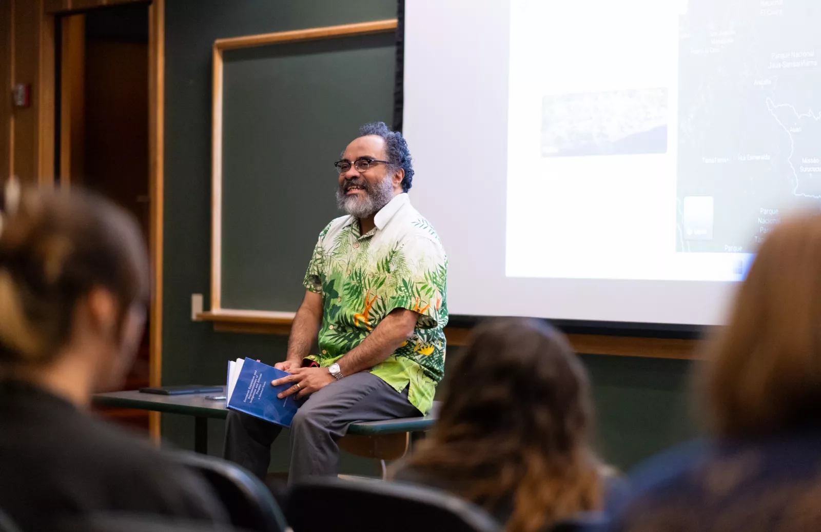 Ignacio Gallup-Diaz sitting on a table in a lecture hall