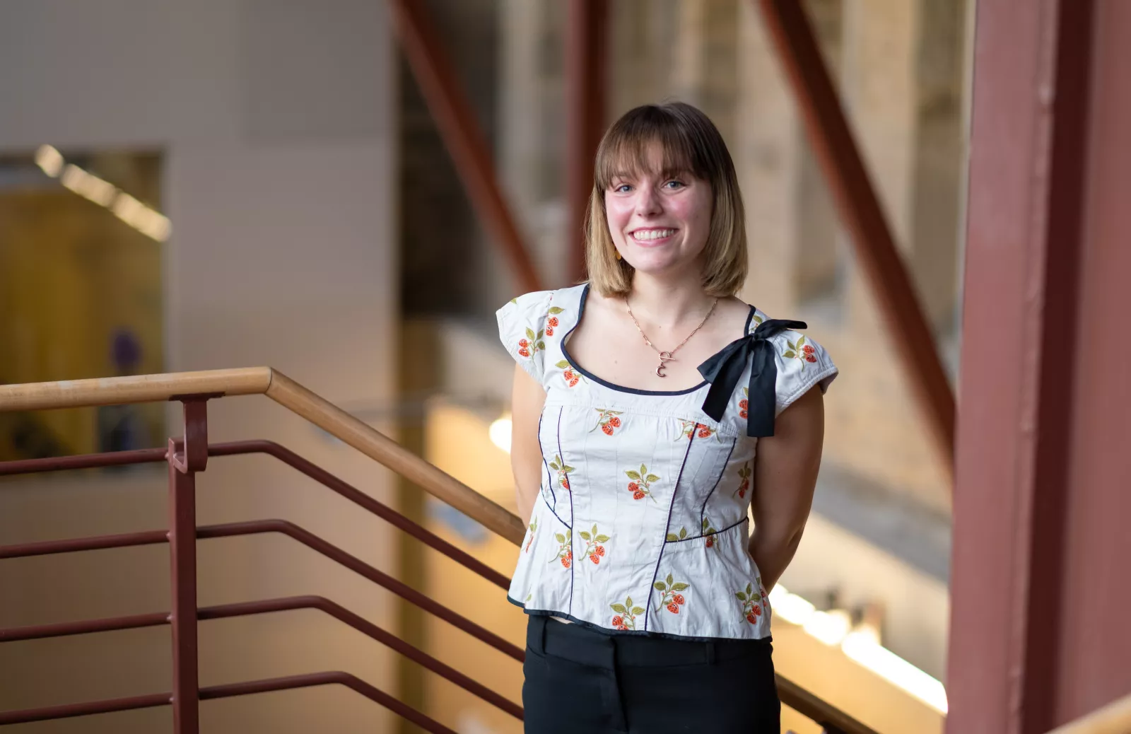 Caroline Robertson standing at the top of Carpenter Library stairs