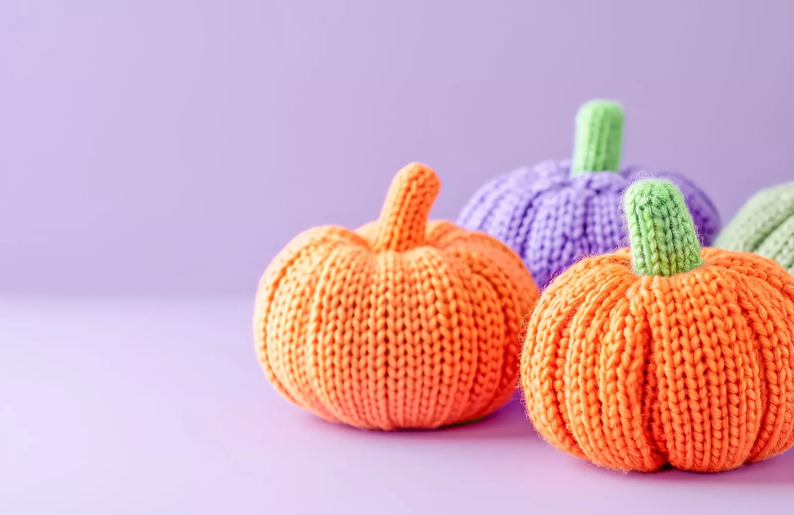 knitted-pumpkins-pastel-purple-background