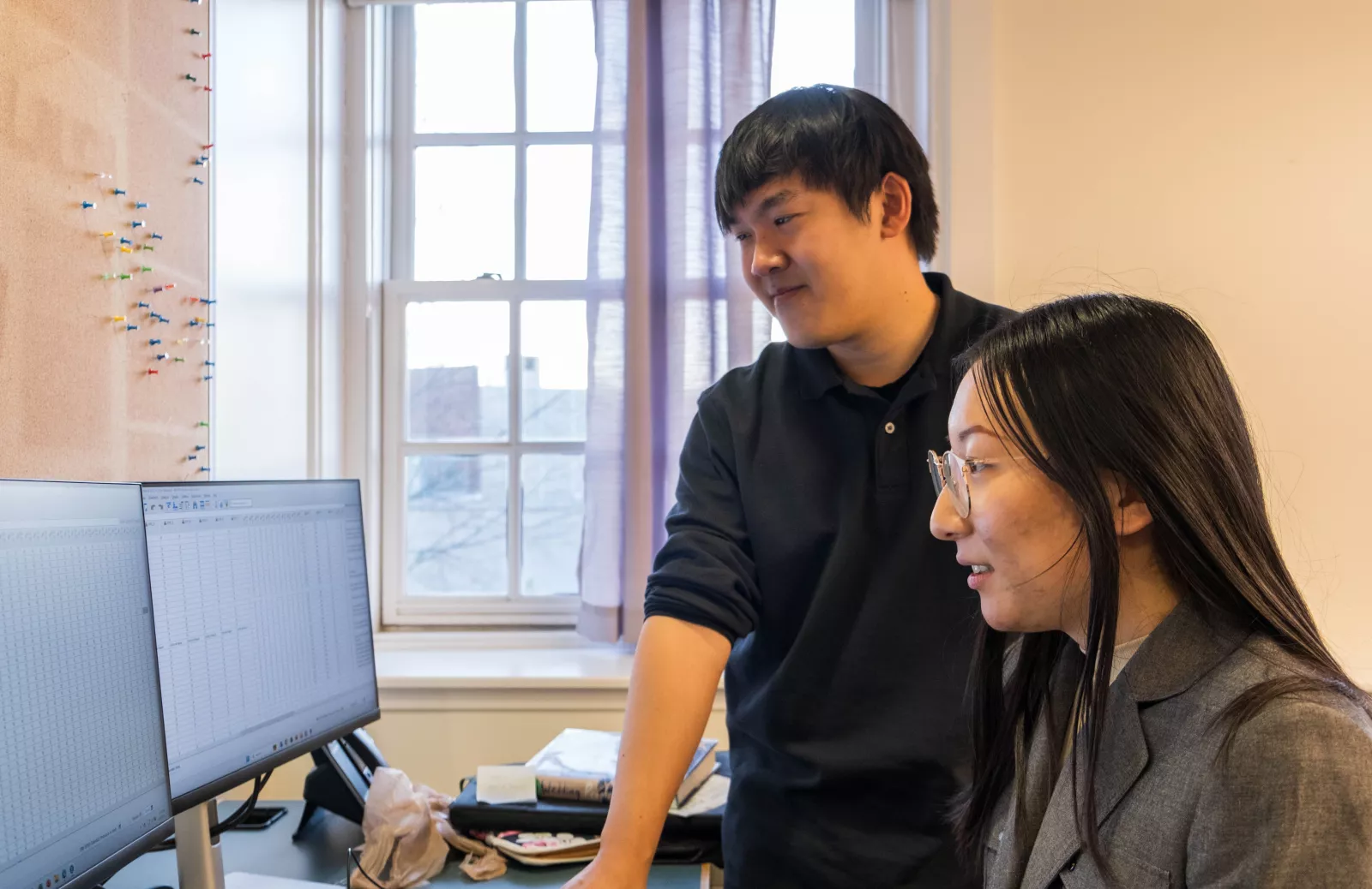 Thomas Le and a student at a computer