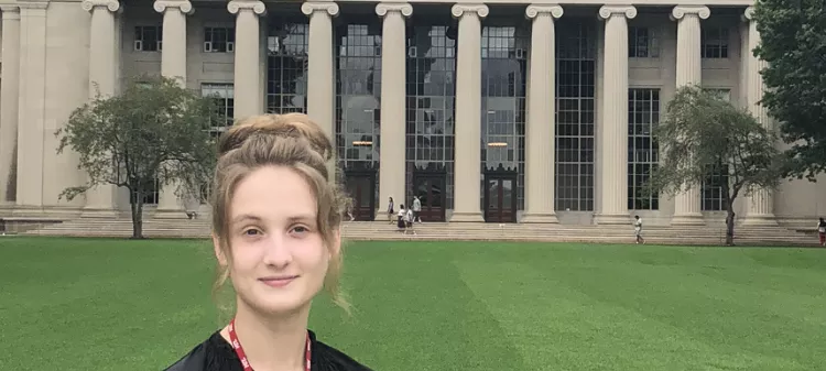 Angelina Rogatch standing in front of a domed building with pillars. 