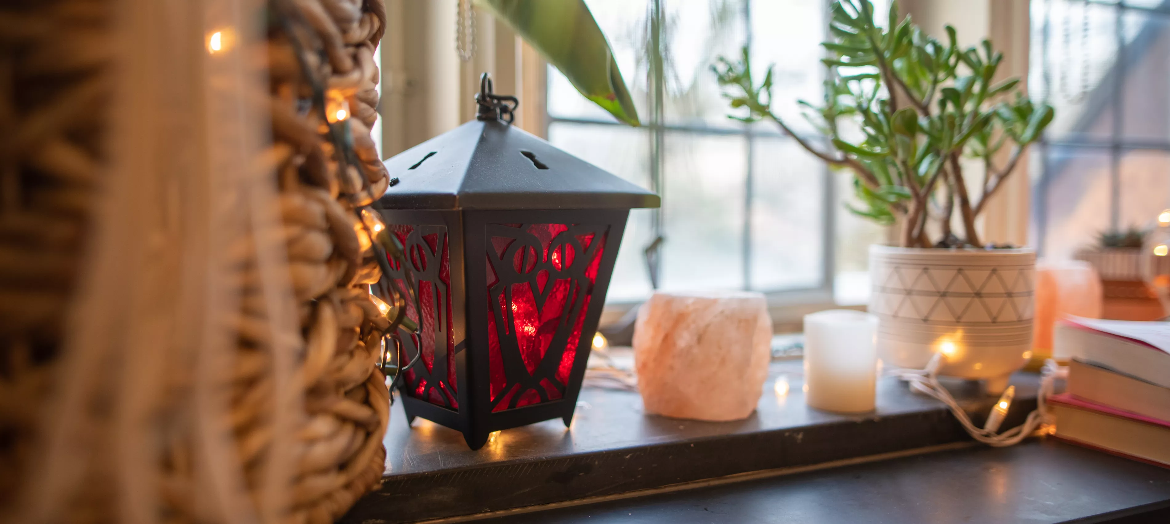 Red lantern, a plant, and other objects on a dorm windowsill.