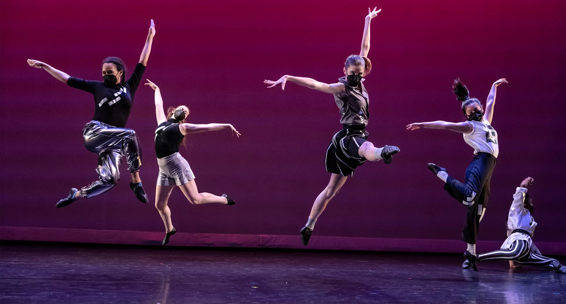 Image of dancers jumping on stage