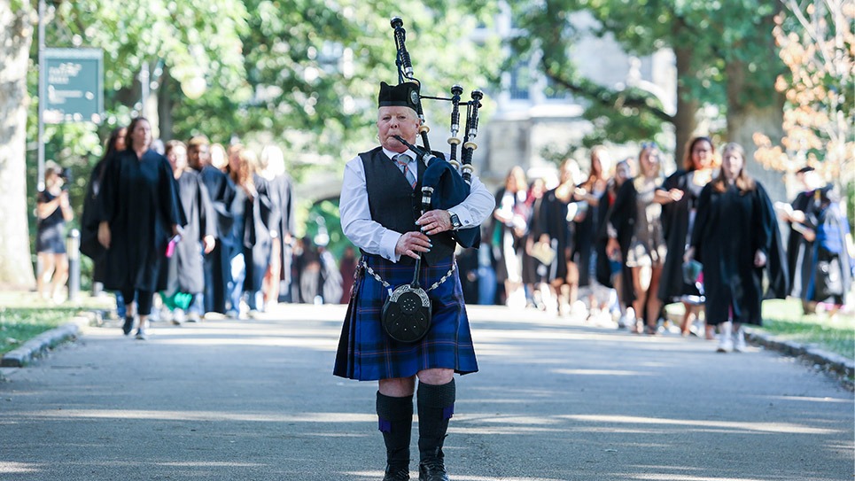 Convocation 2024 Bagpiper Leading the Procession