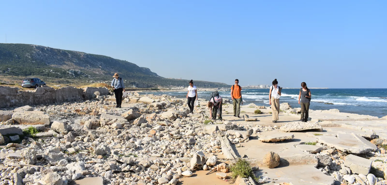 Archaeology students walking along coastline