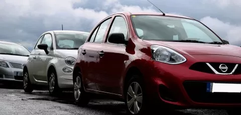 Three cars parked on a road