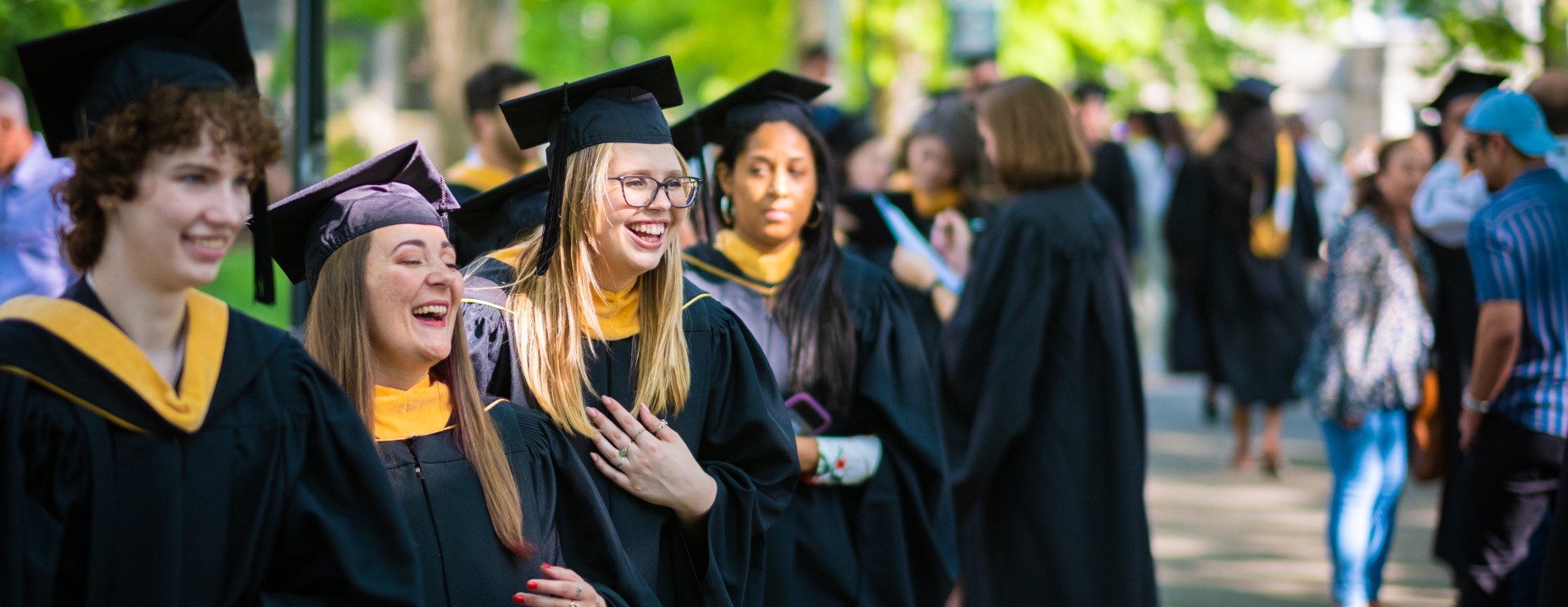 Graduate students lining up on Taylor Drive at Graduate Commencement