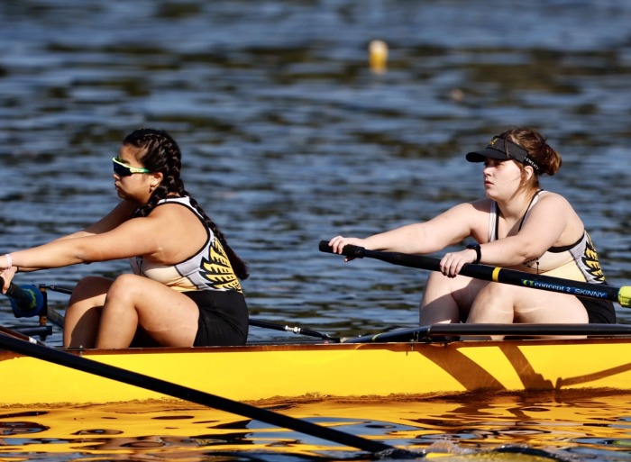 two students rowing