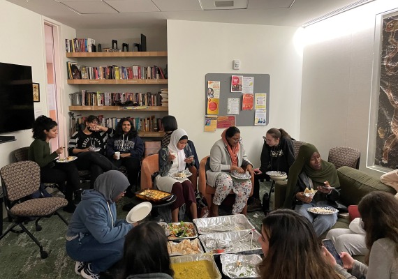 Students enjoying halal food in the Multicultural living room at The Well