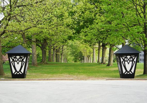 Two large lanterns in front of a row of trees