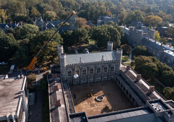 Crane moving materials into cloisters