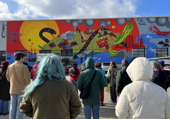 Students looking at Climate Justice Mural