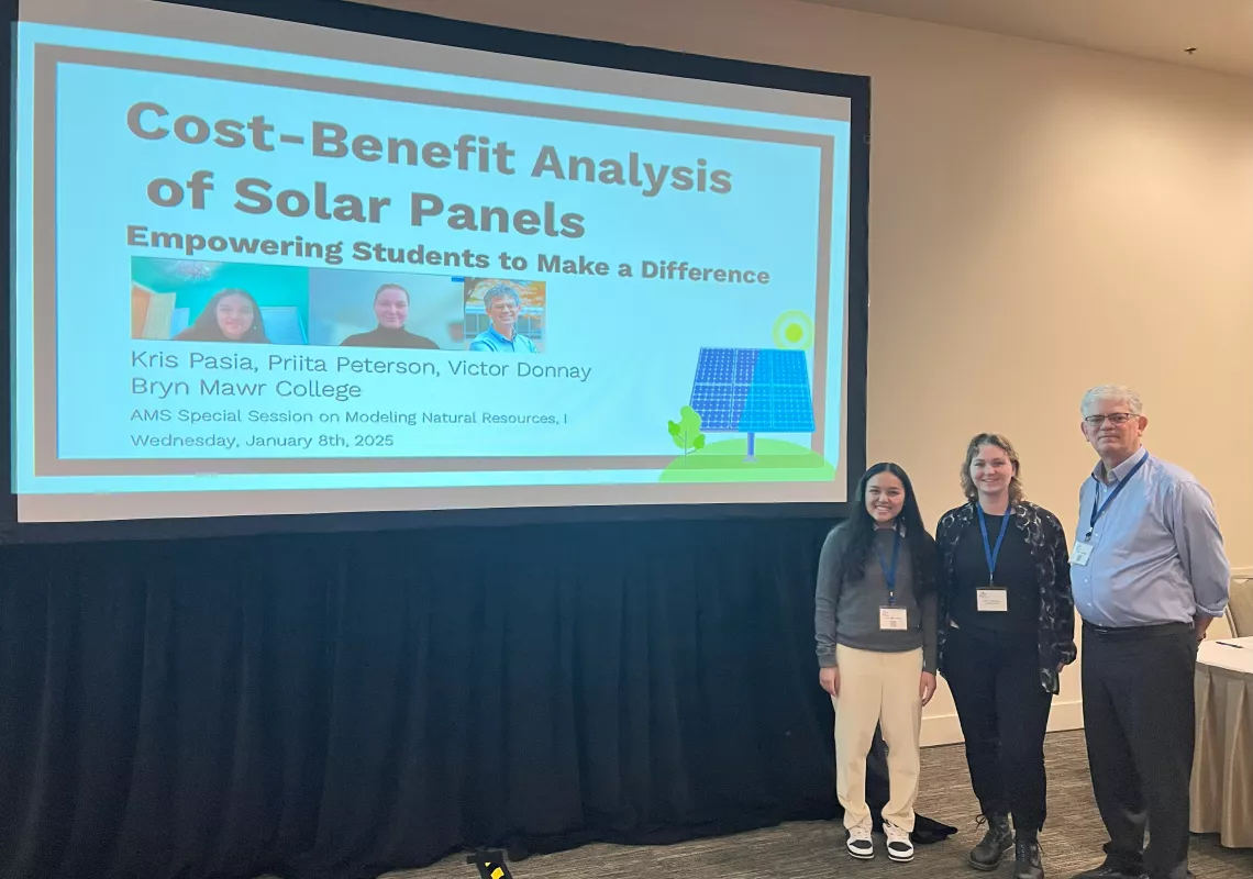 Math students and Victor Donnay in front of presentation titled "Cost-Benefit Analysis of Solar Panels: Empowering Students to Make a Difference"