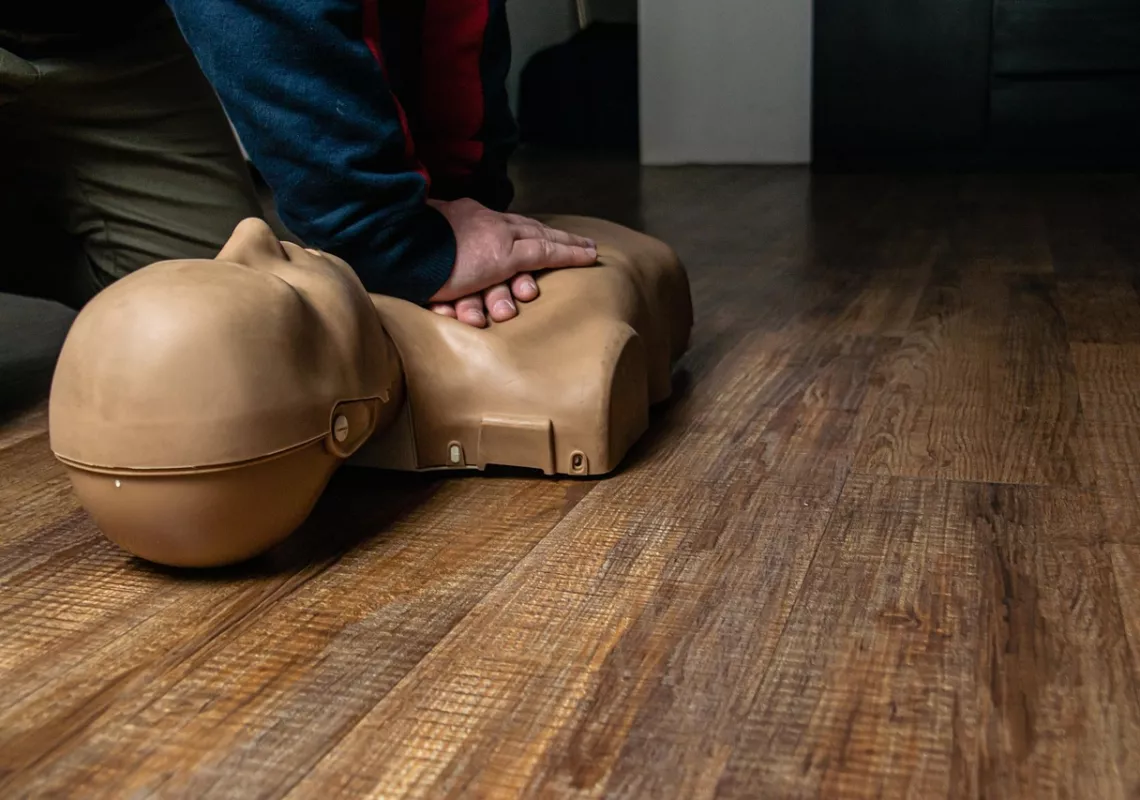 Hands pressing on a CPR dummy 