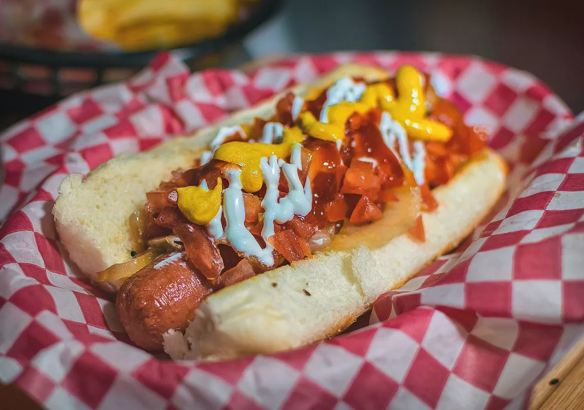 Hot dog with ketchup and mustard and toppings