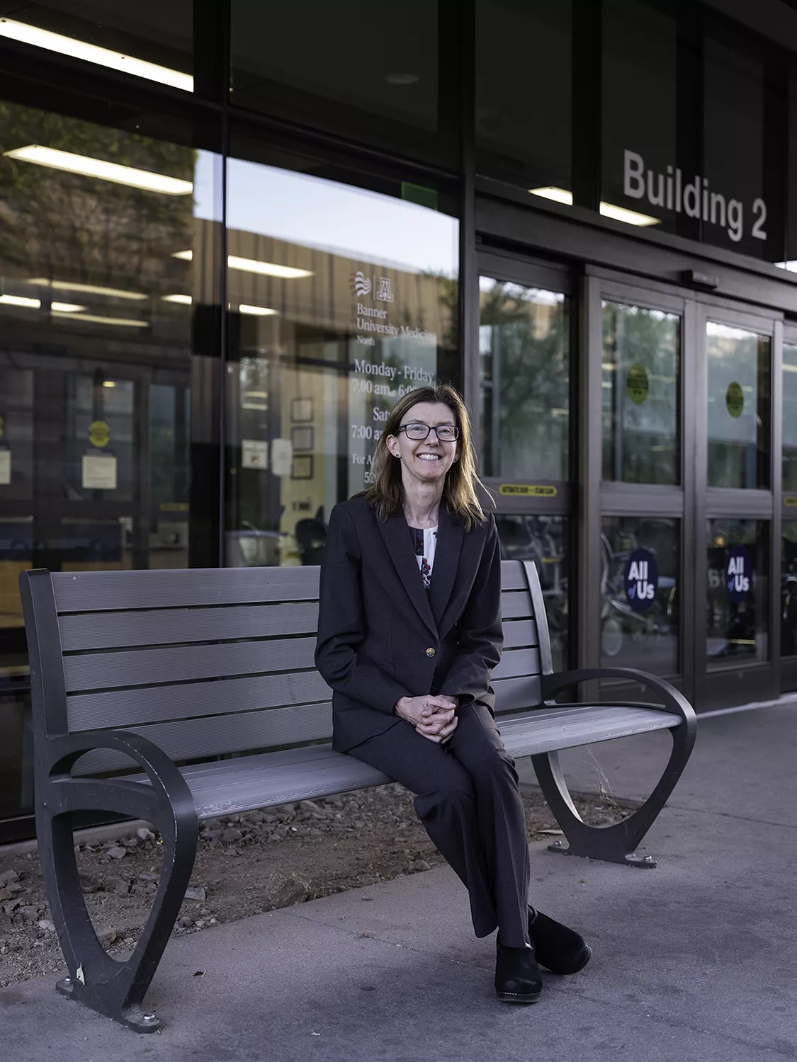 Holli Horak '90 sitting on a bench