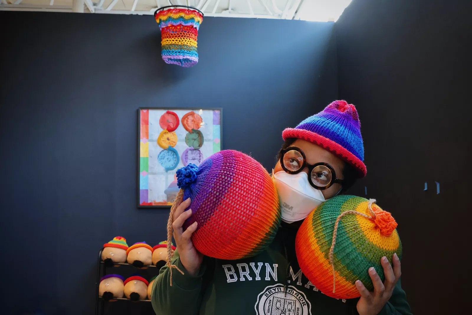 Wit López photographed in The Galleries at Moore with their artwork. Photo by Emma Lee, WHYY