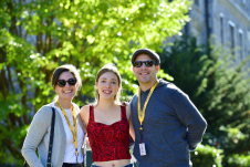 Daughter and 2 parents smiling at the camera