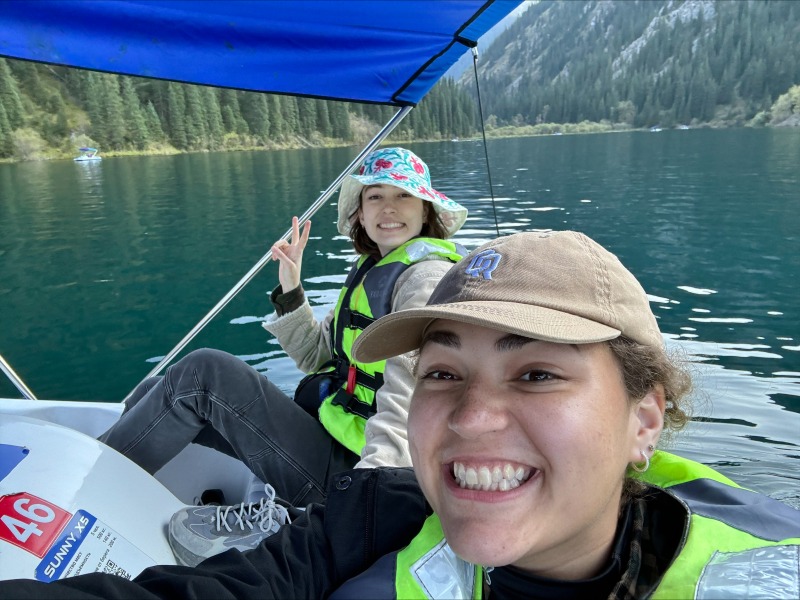 two Boren scholars kayaking on a mountain lake