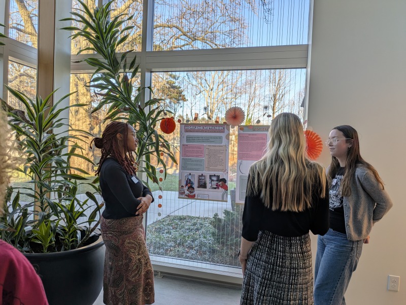 ARJ Students engaging with campus staff during the Praxis poster session