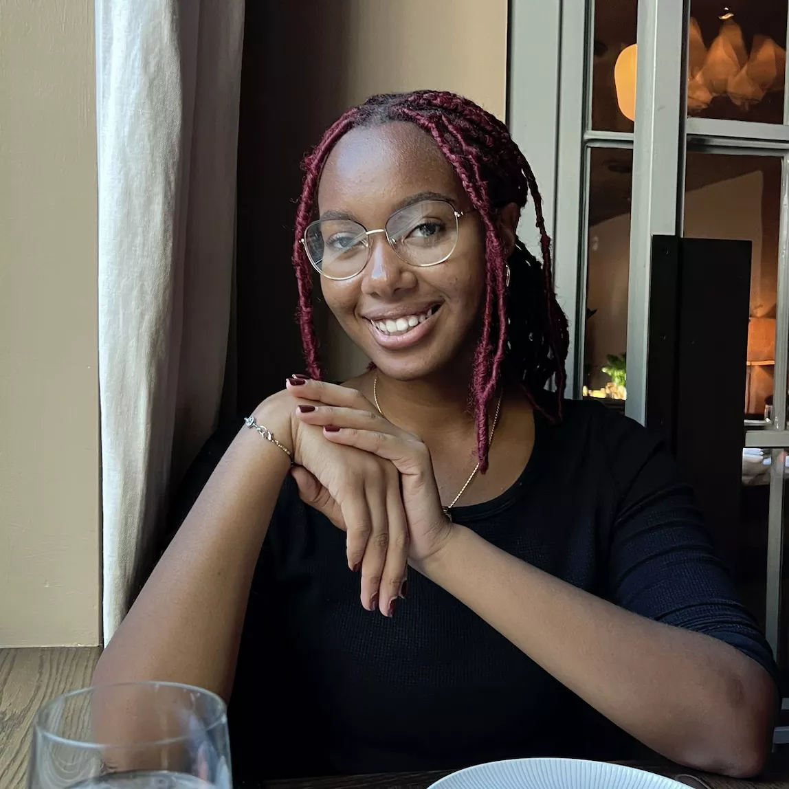 Nyla McNeil sitting at a table and smiling